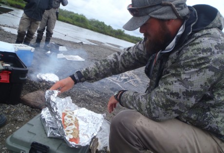 Cooking salmon over an open fire