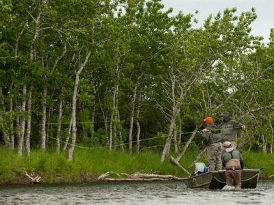 Fly fishing for trout from a boat by Cameron Miller.