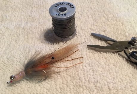 Adjusting weight of your bonefish fly on the water.