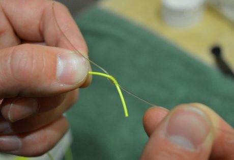 Tying nail knots.